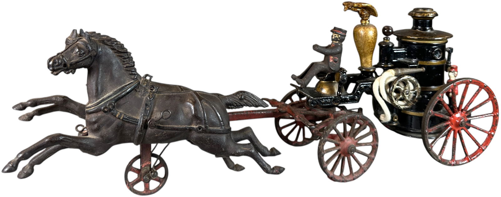 IVES 1912 PHOENIX CLOCKWORK FIRE PUMPER: 121. IVES 1912 PHOENIX CLOCKWORK FIRE PUMPER | 19.5" l. | Original paint worn on front end, eagle and rear figure are typical replacements, rear end is lacquered, (Very Good to Excellent Condition) |