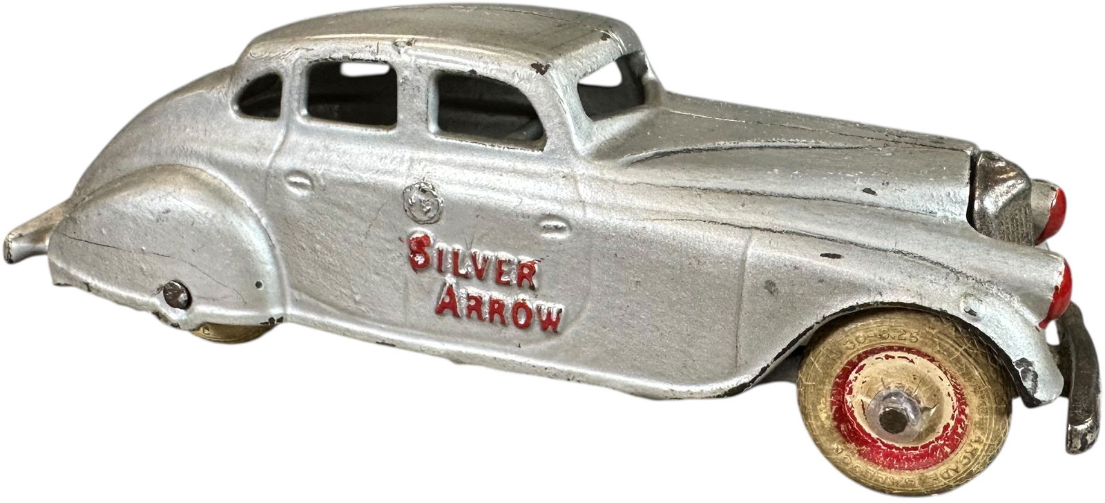 ARCADE SILVER ARROW SEDAN: 148. ARCADE SILVER ARROW SEDAN | 7" l. | Wear to rubber wheels, paint in (Pristine Condition) | $200 - $400