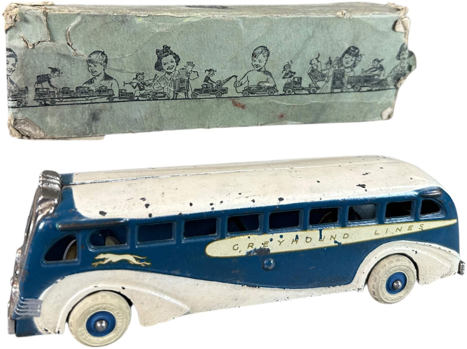 BOXED ARCADE GREYHOUND BUS: 165. BOXED ARCADE GREYHOUND BUS | 8.5" l. | Box has one attached flaps, others are missing, toy in (Very Good to Excellent Condition) | $150 - $300