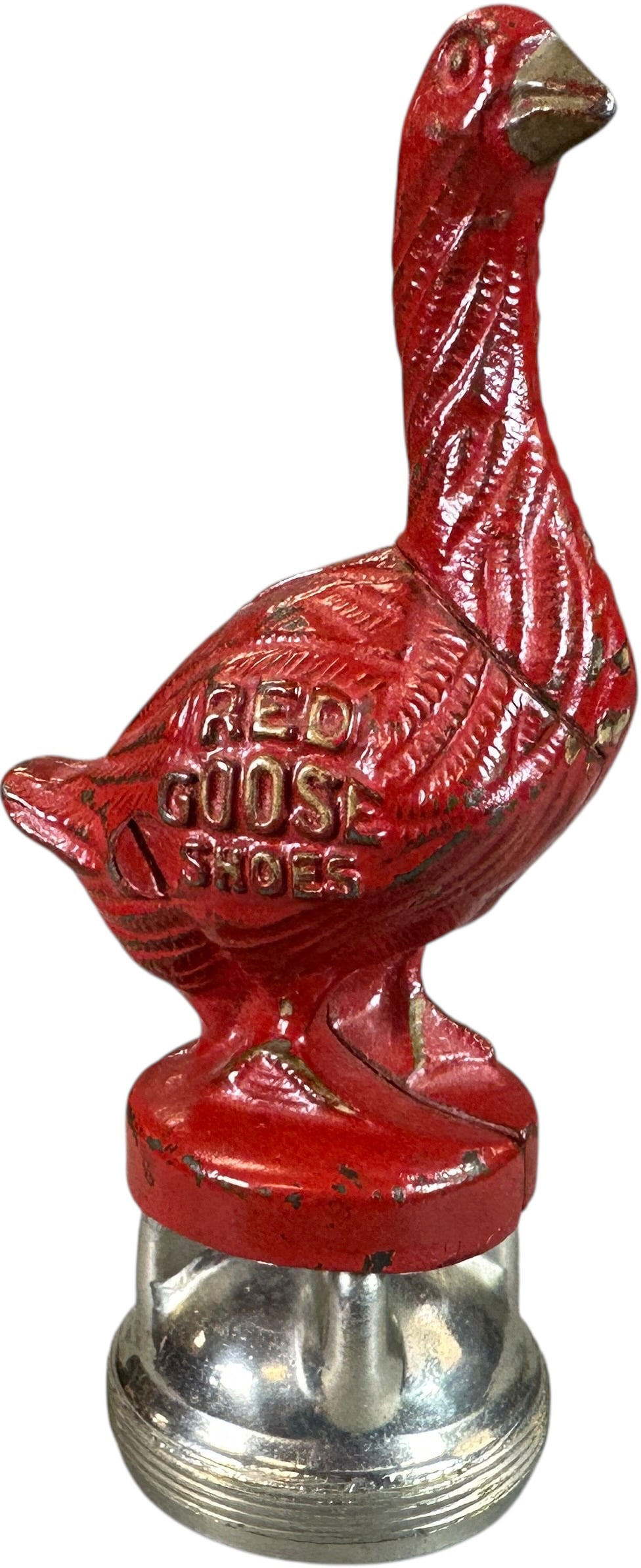 RED GOOSE SHOES RADIATOR CAP BANK: 256. RED GOOSE SHOES RADIATOR CAP BANK | Similar figural still bank with circular base affixed to a radiator cap for mounting on 1920s automobiles. | 6" h. | (Excellent Condition) | $150 - $300