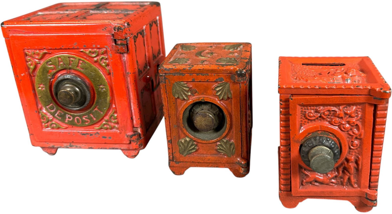 THREE RED SAFE STILL BANKS: 277. THREE RED SAFE STILL BANKS | Henry Hart Mfg. | 5" h. | Safe Deposit missing part of locking mechanism, (Excellent Condition) | $200 - $400