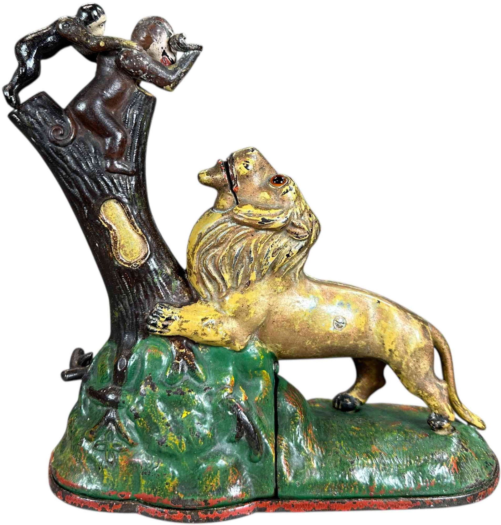 LION & MONKEYS MECHANICAL BANK: 341. LION & MONKEYS MECHANICAL BANK | Kyser & Rex Mfg. Co. | 9" h | Original arms while small monkey is the typical replacement, some gold highlights are overpainted on lion, colorful original base,