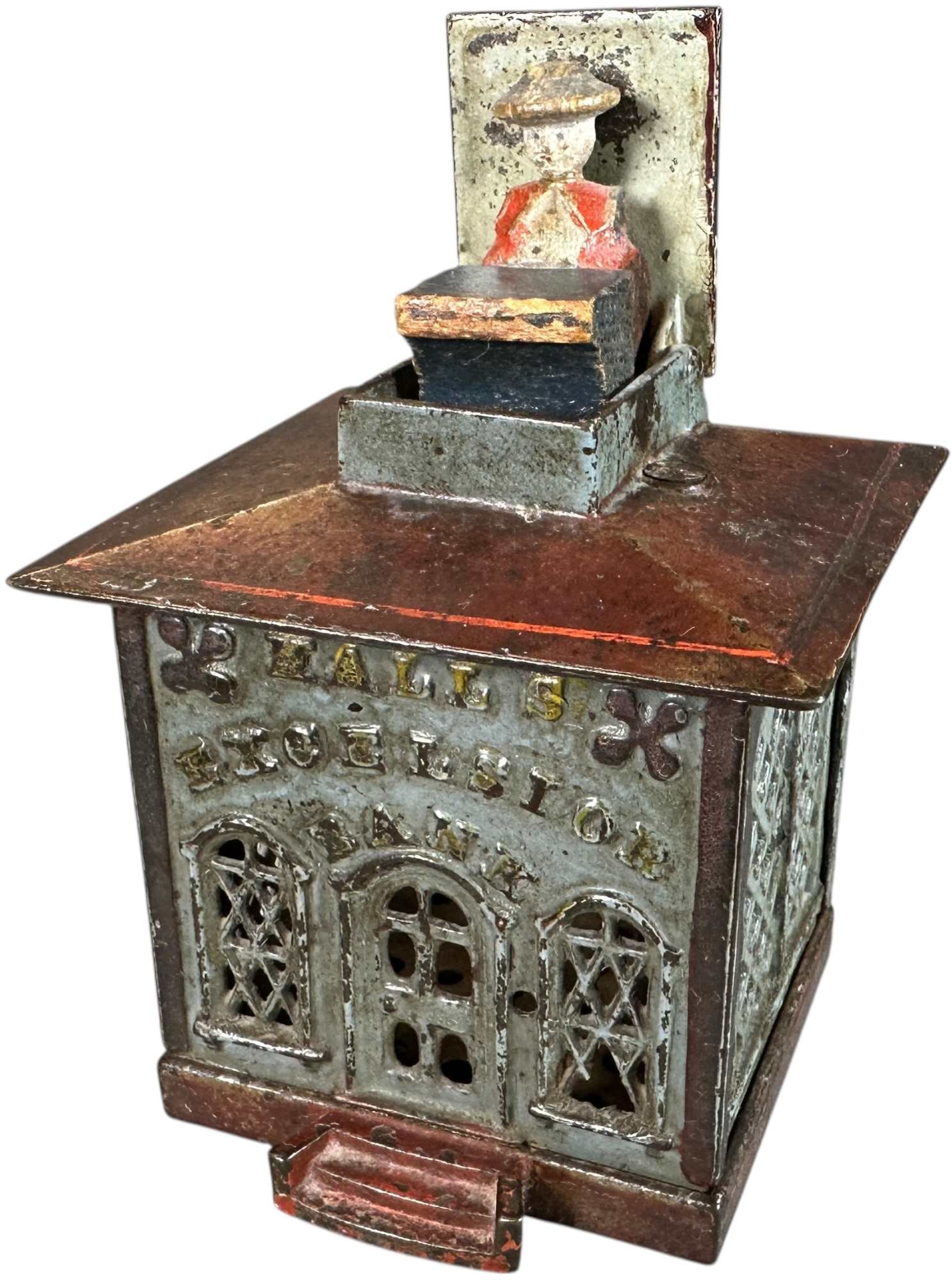 HALLS EXCELSIOR MECHANICAL BANK: 388. HALLS EXCELSIOR MECHANICAL BANK | J&E Stevens Co. | 5" h. | Authentic cashier head is unusual, hairline to top edge of side panel, (Very Good Condition) | $100 - $200