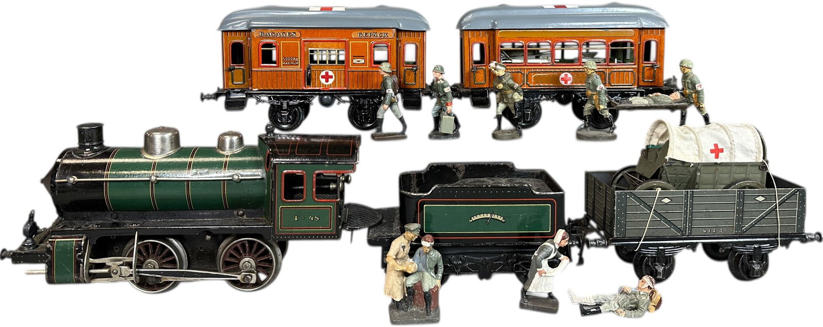 LARGE BING MEDICAL MILITARY 1GAUGE TRAIN GROUP: 16. LARGE BING MEDICAL MILITARY 1GAUGE TRAIN GROUP | Extensive grouping to include Wind Cutter #48 engine and tender, five hospital cars with interiors (two roofs repainted) two medical wagons, and a