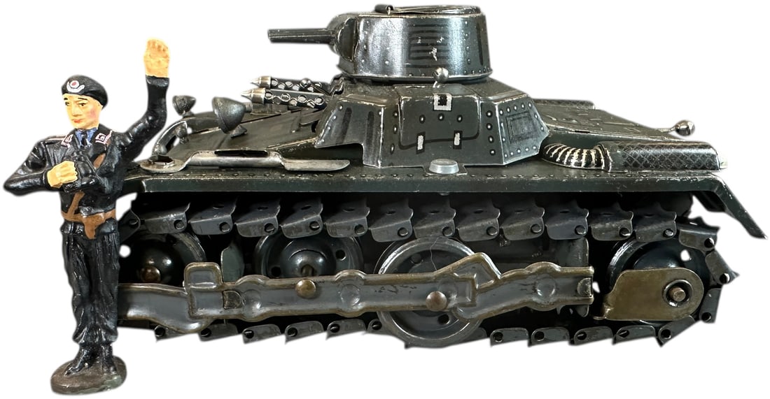 GAMA PREWAR TINPLATE TANK: 37. GAMA PREWAR TINPLATE TANK | Working wind-up motorized tank with metal treads, comes with re-issue composition tank commander. | 7.5" l. | (Excellent Condition) | $200 - $300