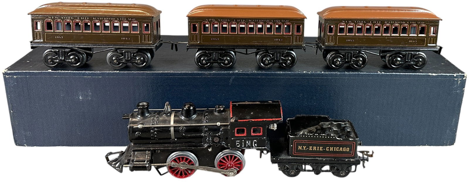 BING NEW YORK ERIE CHICAGO TRAIN SET: 41. BING NEW YORK ERIE CHICAGO TRAIN SET | O gauge, wind-up. | 6.5" l. loco | Two repainted roofs, car bodies have miniscule touch-ups to chips, (Very Good to Excellent Condition) | $600 - $1,000