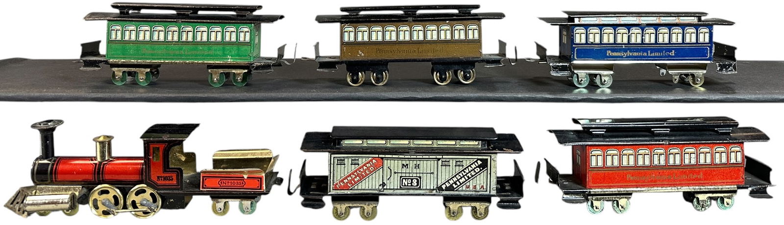 ISSMAYER AMERICAN MARKET PENNY TOY TRAIN SET: 46. ISSMAYER AMERICAN MARKET PENNY TOY TRAIN SET | Provenance: The Chuck Ehlers Hess Collection. | 8" l. | Vestibule roof on baggage car is replaced, otherwise in (Excellent to Pristine Condition) | $