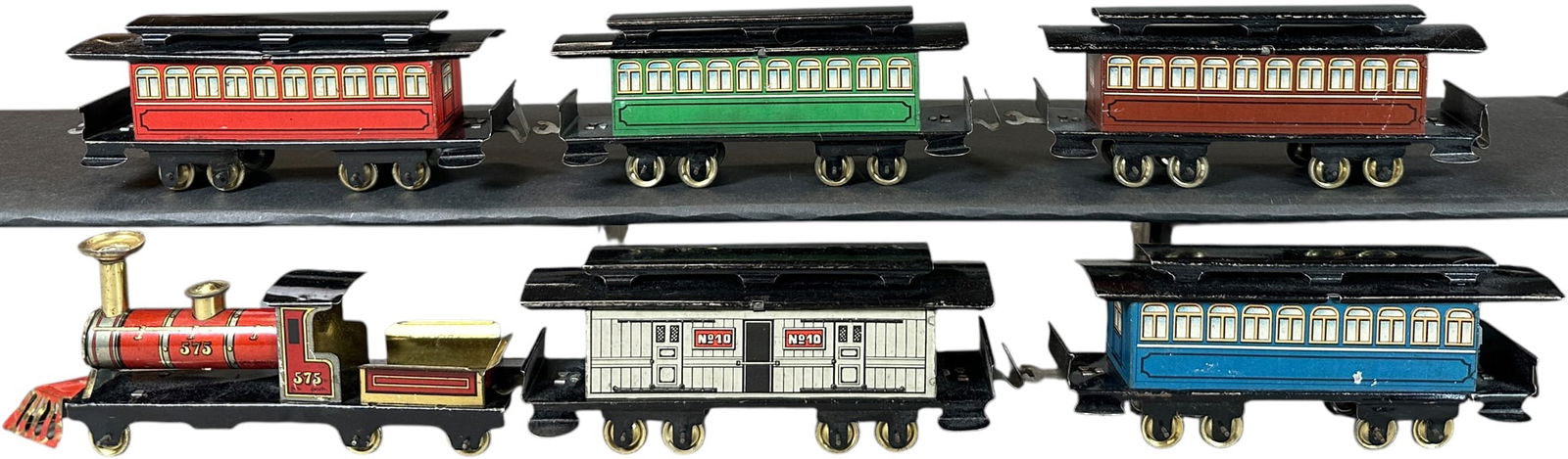 COLORFUL ISSMAYER PENNY TOY TRAIN SET: 48. COLORFUL ISSMAYER PENNY TOY TRAIN SET | Unpowered floor train. Provenance: The Chuck Ehlers Hess Collection. | 8" l. | (Excellent Condition) | $400 - $800
