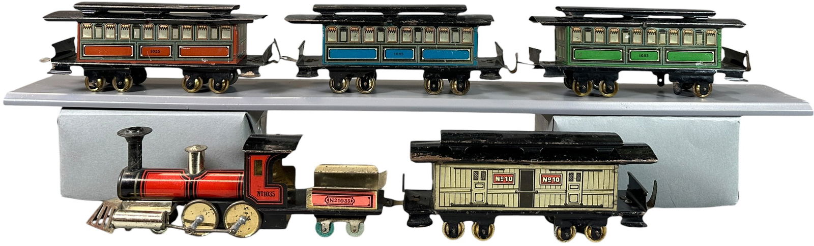 HESS AMERICAN MARKET PASSENGER TRAIN SET: 50. HESS AMERICAN MARKET PASSENGER TRAIN SET | Litho, unpowered floor train. Provenance: The Chuck Ehlers Hess Collection. | 8" l. | Two sets of wheels absent, otherwise complete and in wonderful (Exc