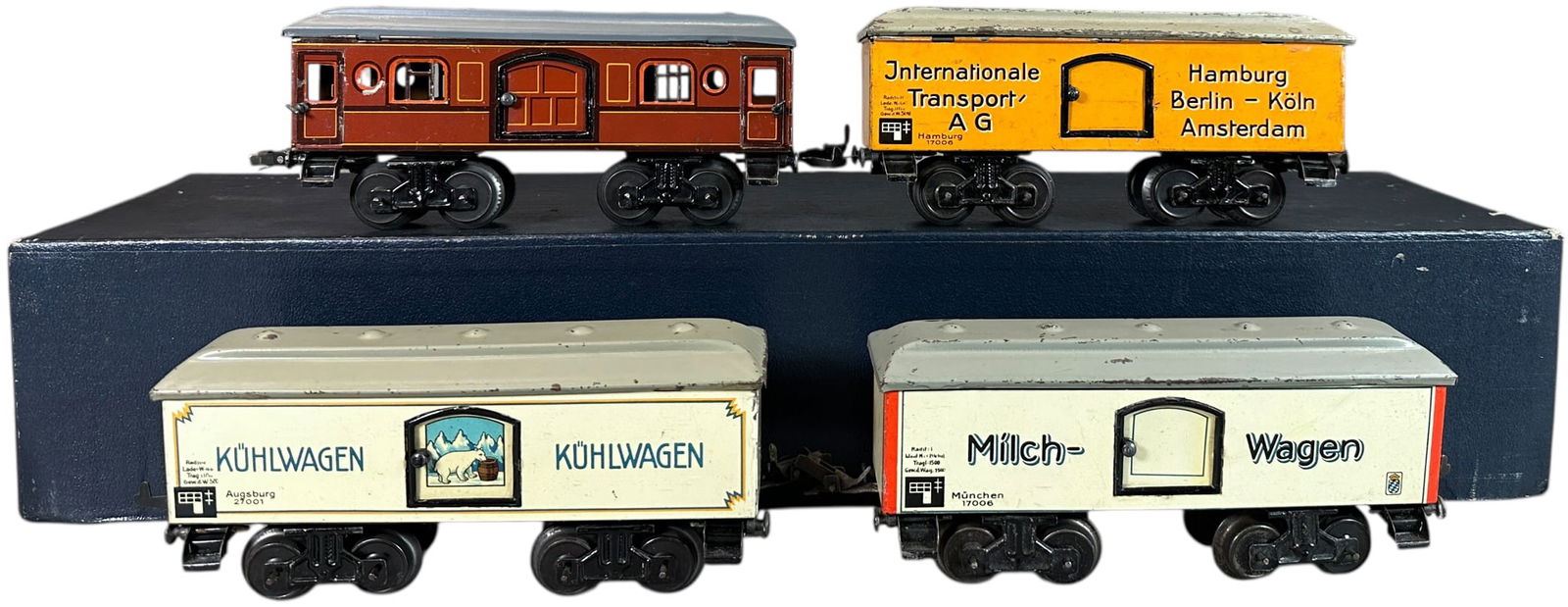 FOUR KARL BUB FREIGHT WAGONS: 59. FOUR KARL BUB FREIGHT WAGONS | O gauge. | 8" l. | Nice lithographed bodies, grey roof is repainted, other roofs have scratching, still grades in (Excellent Condition) | $300 - $600