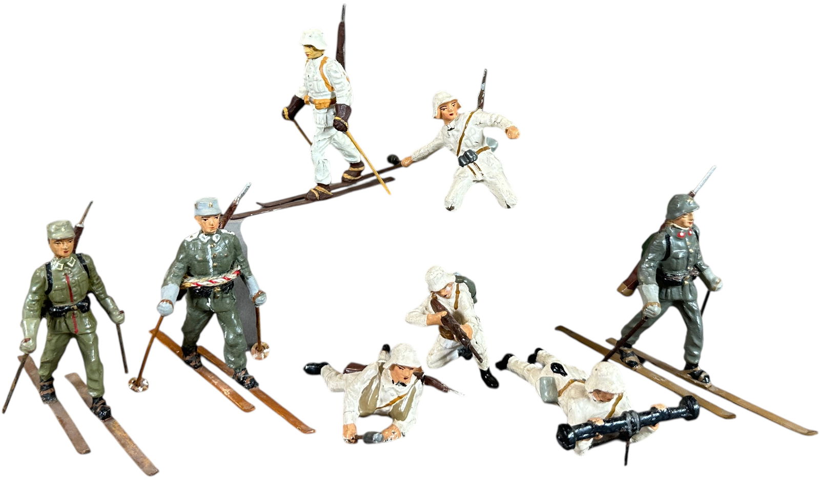 LINEOL WINTER SOLDIERS: 65. LINEOL WINTER SOLDIERS | Eight soldier lot to include four Danish soldiers in white uniforms, one German on skis white uniform, two Germans in field gray uniforms and skis, and one extremely rare