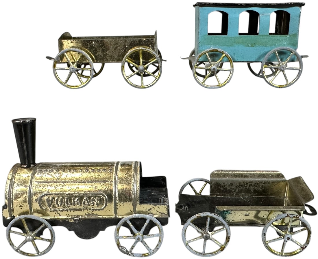 EARLY HESS TINPLATE TRAIN SET: 91. EARLY HESS TINPLATE TRAIN SET | Hand painted coach. Provenance: The Chuck Ehlers Hess Collection. | 3.5" l. loco | Minimal wear and tear to cardboard box with a wonderful graphic label, (Excellent