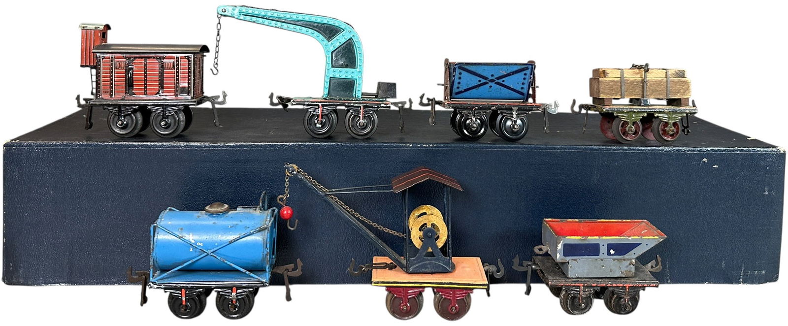 SIX EARLY BING FREIGHT TRAIN CARS: 103. SIX EARLY BING FREIGHT TRAIN CARS | O gauge. | 4" l. | Some old repaint to crane car, otherwise early set is (Very Good to Excellent Condition) | $300 - $600