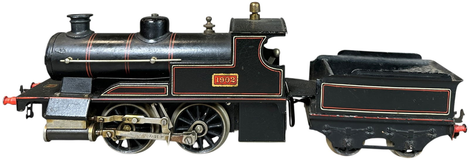 BING 1902 LIVE STEAM LOCOMOTIVE: 108. BING 1902 LIVE STEAM LOCOMOTIVE | O gauge, live steam, hand painted. | 8.5" l. loco | Some very minor in-painting to chips, otherwise (Excellent Condition) | $400 - $800