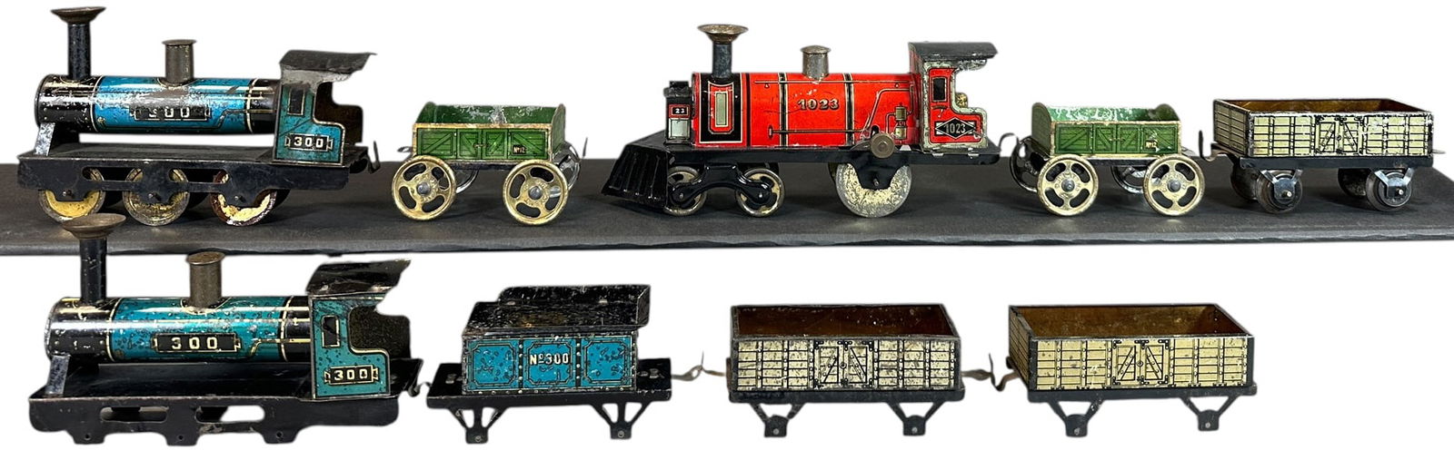 THREE HESS LOCOMOTIVES & CARS: 112. THREE HESS LOCOMOTIVES & CARS | Provenance: The Chuck Ehlers Hess Collection. | 8.5" l. loco | One loco missing wheels, (Very Good Condition) | $200 - $400