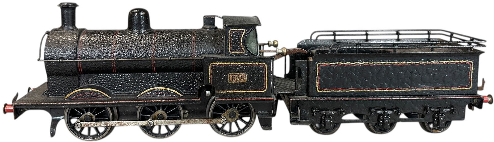 BING FOR BASSETT LOWKE 0-6-0 GOODS LOCO: 127. BING FOR BASSETT LOWKE 0-6-0 GOODS LOCO | Gauge 1, clockwork, hand painted. | 10" l. loco | Appears to be old overpaint which is heavily crazed with a thick lacquer creating a fabulous alligator