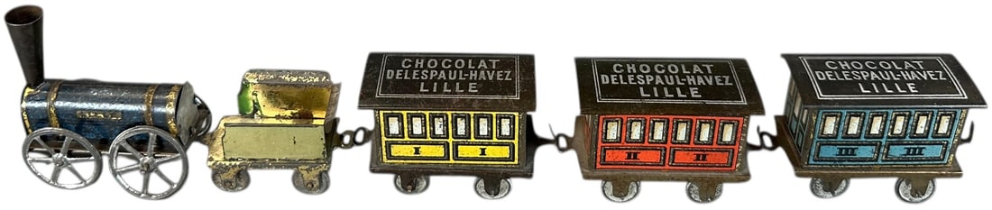 RARE HESS CHOCOLATE TRAIN: 135. RARE HESS CHOCOLATE TRAIN | Unpowered floor train. Provenance: The Chuck Ehlers Hess Collection. | 12" l. set | Blue car appears to have a professionally made roof under blacklight UV, otherwise