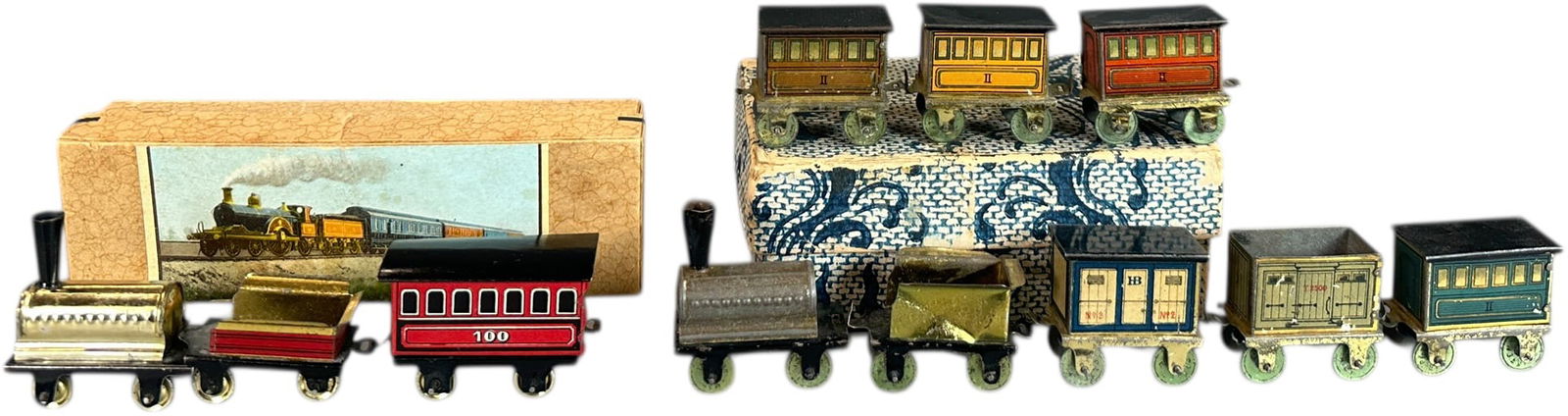 BOXED HESS PENNY TOY TRAIN SETS: 136. BOXED HESS PENNY TOY TRAIN SETS | Un-powered floor trains. Provenance: The Chuck Ehlers Hess Collection. | 6" l, 14.5" l. sets | Split to side of original lid, (Pristine to Near Mint Condition) |