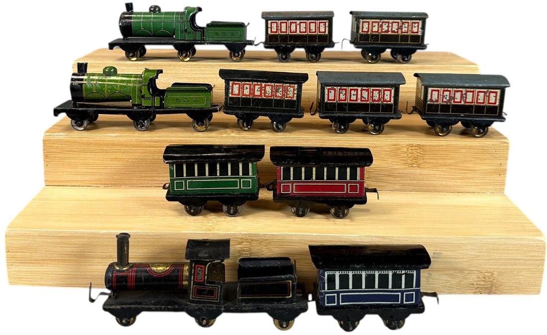 HESS PENNY TOY PASSENGER TRAIN SETS: 140. HESS PENNY TOY PASSENGER TRAIN SETS | Provenance: The Chuck Ehlers Hess Collection. | 3" l. loco | Boiler cap repainted on one loco, otherwise sets in (Very Good to Excellent Condition) | $300 -