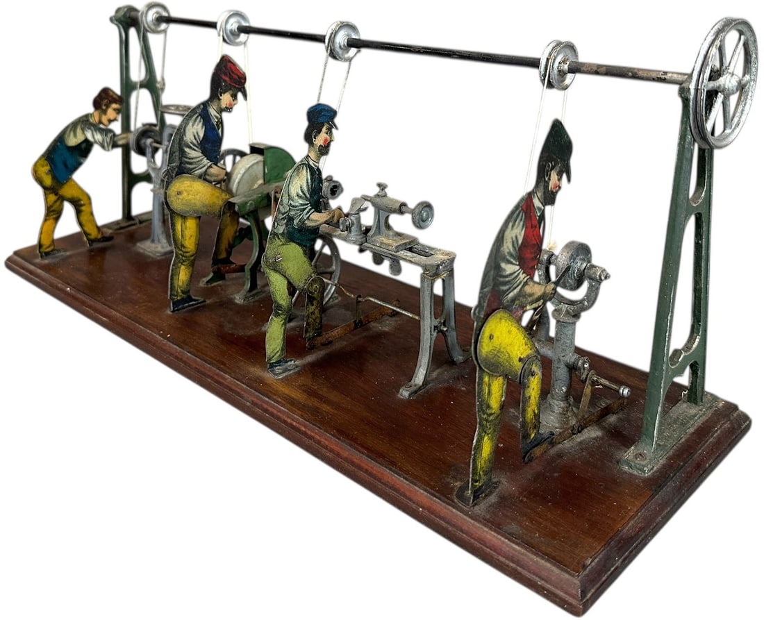 GERMAN STEAM POWERED MACHINE SHOP TOY: 146. GERMAN STEAM POWERED MACHINE SHOP TOY | Litho figures with hand painted machines, attributed to Carette. | 17.5" l. | (Excellent Condition) | $400 - $800