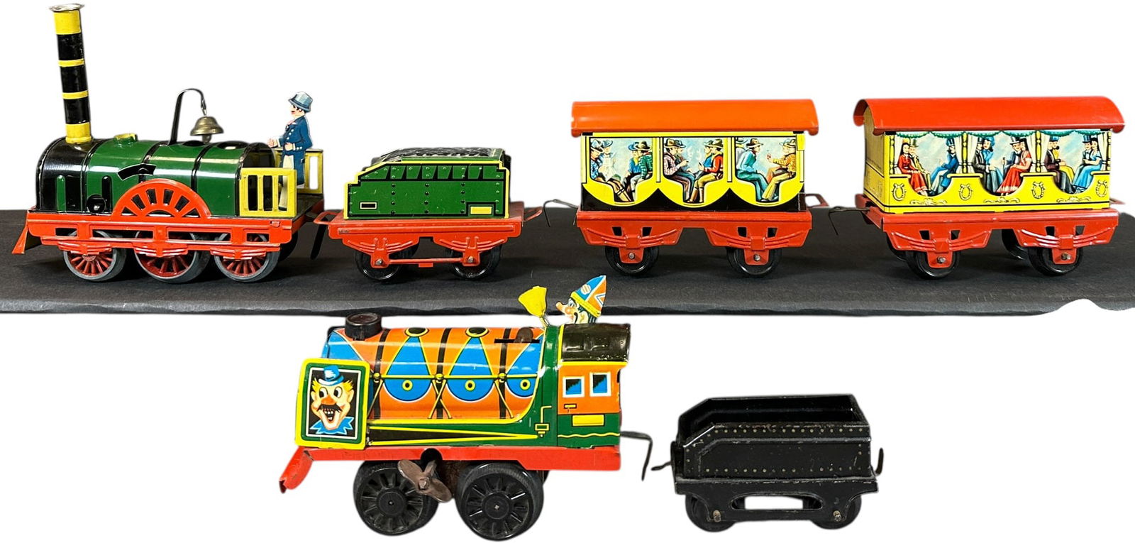 KARL BUB CIRCUS LOCOMOTIVE & DER ADLER SET: 157. KARL BUB CIRCUS LOCOMOTIVE & DER ADLER SET | O gauge, wind-up, colorful lithography. Provenance: The Chuck Ehlers Hess Collection. | 4.5" l. | Top surface of one red roof is overpainted, otherwis