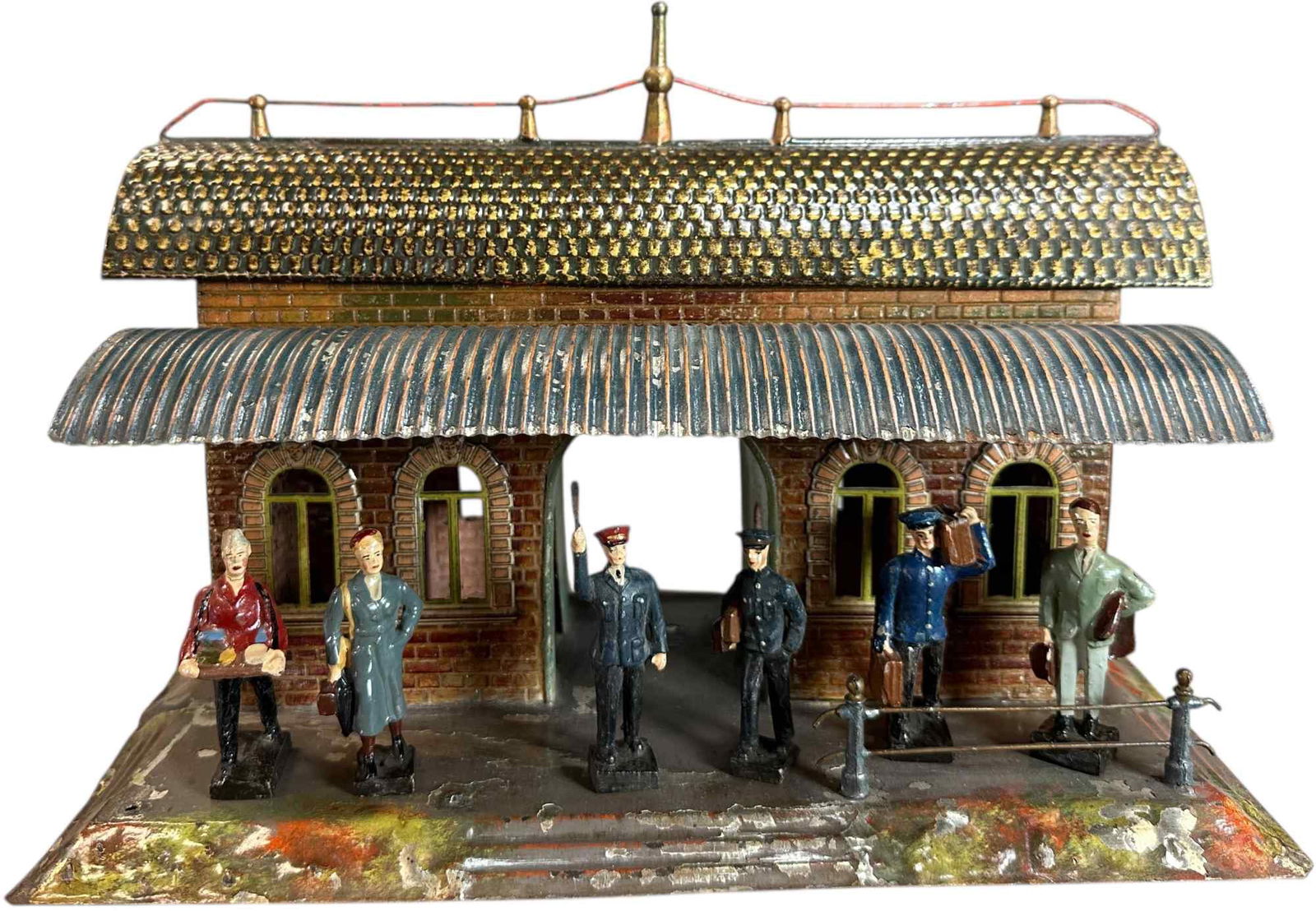 EARLY BING PASSENGER STATION W/ LEYLA FIGURES: 161. EARLY BING PASSENGER STATION W/ LEYLA FIGURES | Gauge 1, hand painted, includes six Layla composition railroad figures. | 14 x 8" lw. | One roof end replaced, base and roof clear-coated to preven