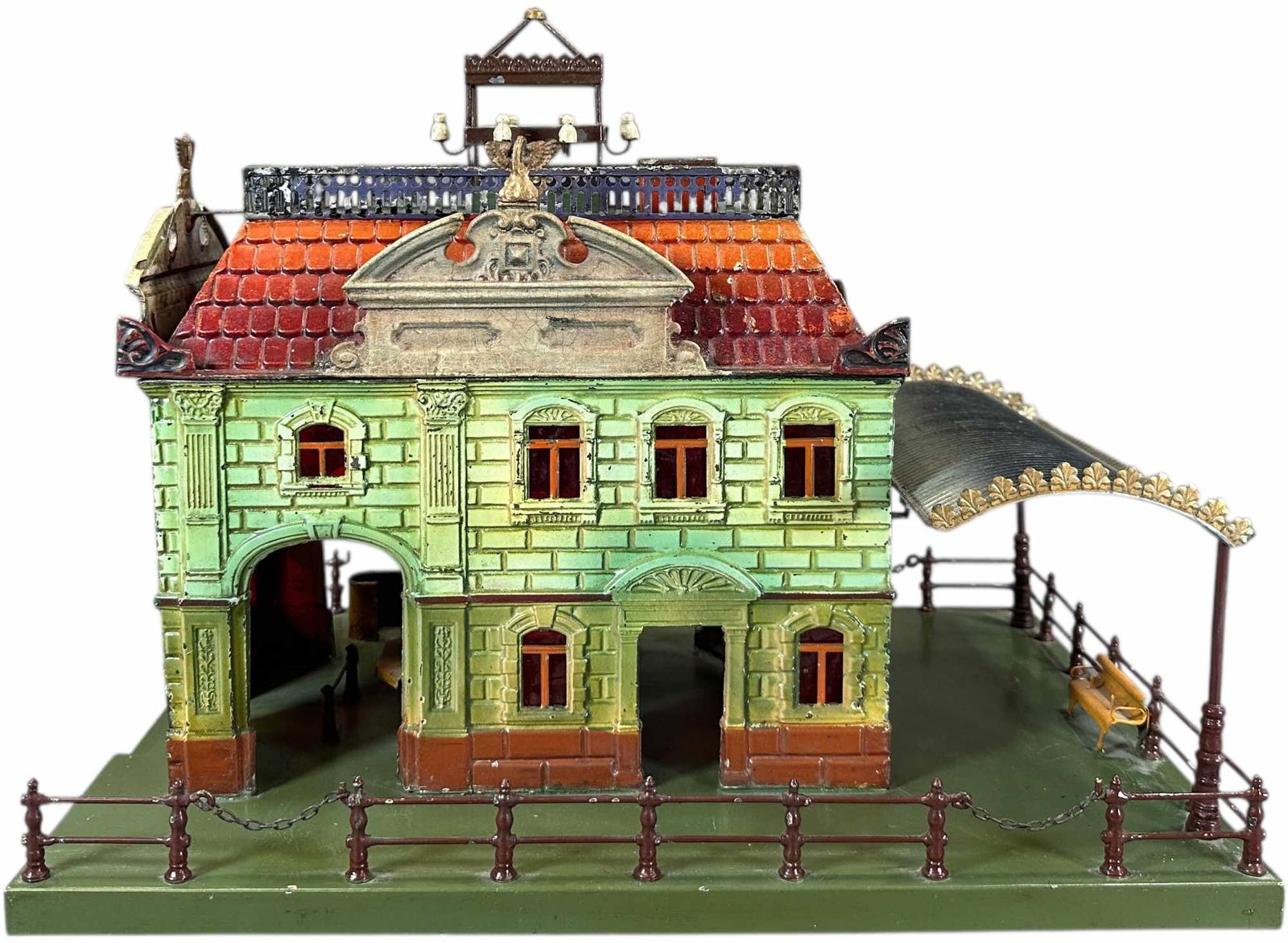 EARLY BING PASSENGER STATION: 164. EARLY BING PASSENGER STATION | Hand painted, catalog no.13175, circa 1912. | 17 x 13" lw | Base restored, two corner finials replaced on roof, station clear coated to protect original paint, disp