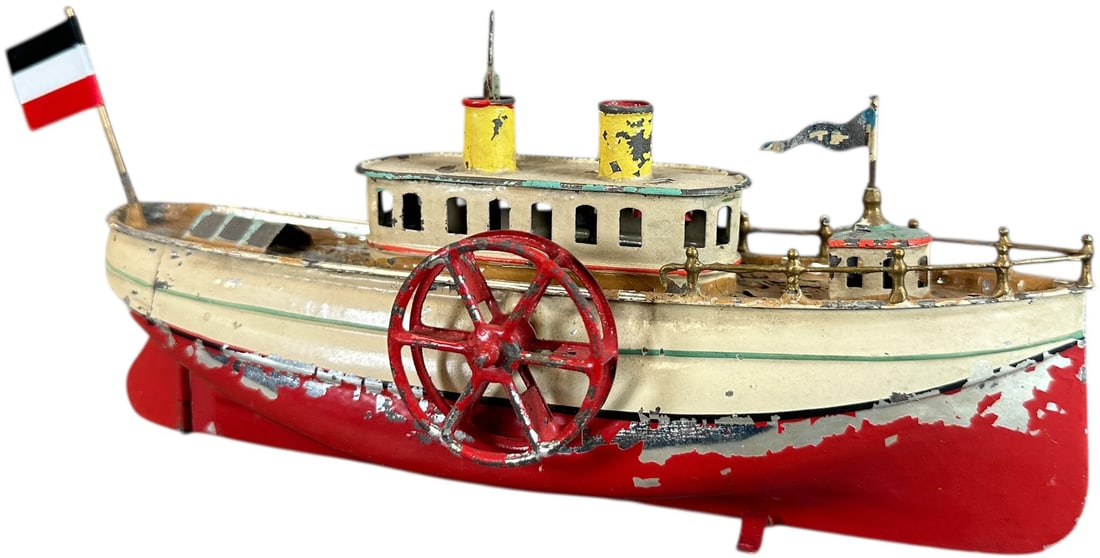 FLEISCHMANN SIDEWHEELER BOAT: 196. FLEISCHMANN SIDEWHEELER BOAT | Reference No. 72R. | 9" l. | Great boat has authentic paint with flaking, flag added for displaying, (Very Good to Excellent Condition) considering the age. | $300