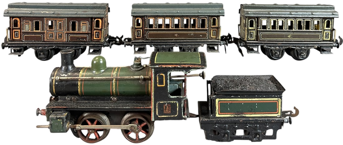 CARETTE PASSENGER TRAIN SET: 209. CARETTE PASSENGER TRAIN SET | O gauge, clockwork, hand painted loco with litho tender and cars. | 7.5" l. loco | (Excellent Condition) | $300 - $600