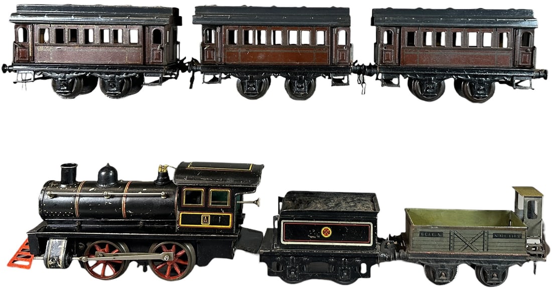 CARETTE AMERICAN MARKET LOCO PASSENGER TRAIN SET: 214. CARETTE AMERICAN MARKET LOCO PASSENGER TRAIN SET | Gauge 1, clockwork,. | 11" l. loco | Roofs repainted on three cars, touch-up to cow catcher, engine lacquered, (Very Good to Excellent Condition