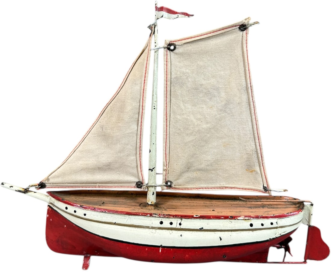 EARLY GERMAN HAND PAINTED SAILBOAT: 235. EARLY GERMAN HAND PAINTED SAILBOAT | Attributed to Fleischmann. | 11" l. | Canvas has some age, paint on boat appears to have professional enhancement, displays in (Excellent Condition) | $400 -