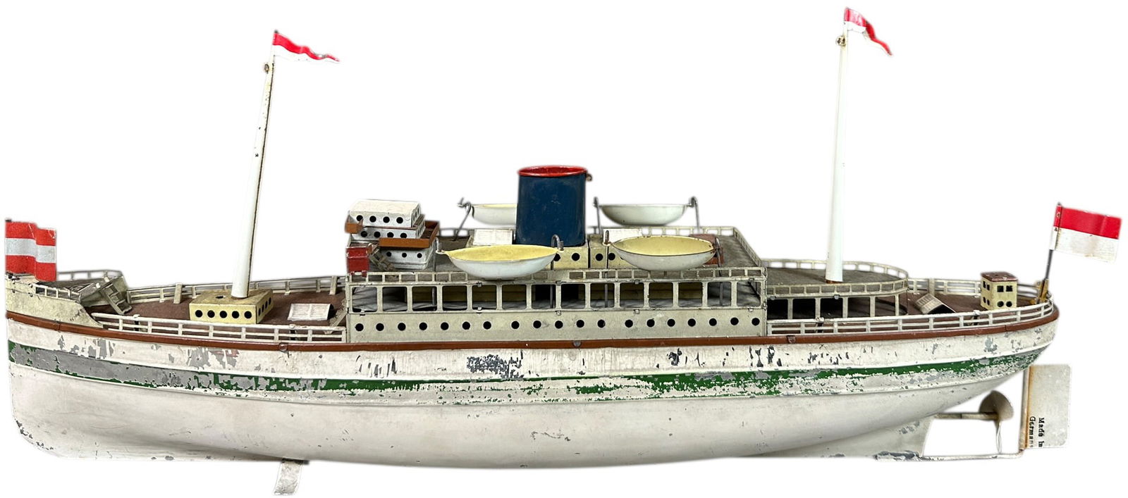 FLEISCHMANN OCEAN LINER - GREEN STRIP: 239. FLEISCHMANN OCEAN LINER - GREEN STRIP | Germany, circa 1950, clockwork motor version. | 20" l. | Front flag is original, one original lifeboat, others replaced, original hull paint in overall (Ve