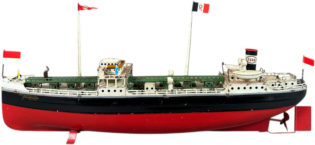 FLEISCHMANN ESSO TANKER: 240. FLEISCHMANN ESSO TANKER | Germany, circa 1950, clockwork motor version. | 20" l. | Masts, flags, and smokestack are replaced, rudder reattached to hull, (Very Good Condition) | $300 - $500