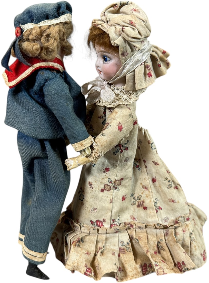 CHARMING GERMAN WIND-UP WALTZING SAILOR COUPLE: 248. CHARMING GERMAN WIND-UP WALTZING SAILOR COUPLE | Ex: The Tony Cuff UK Collection. | 10" h. | One hand replaced on boy, clothing is age appropriate, (Excellent Condition) | $500 - $1,000