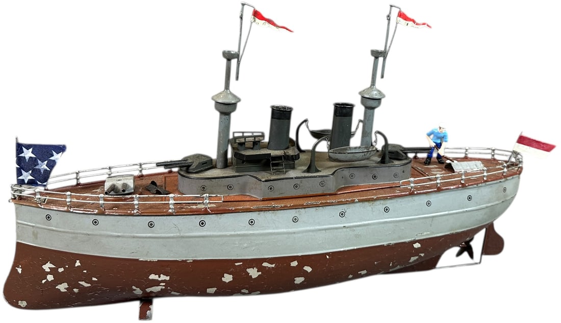 HAND PAINTED FLEISCHMANN BATTLESHIP: 256. HAND PAINTED FLEISCHMANN BATTLESHIP | Hand painted, clockwork. | 17" l. | Flags, masts, and one lifeboat replaced, flaking to hull has been stabilized, (Very Good to Excellent Condition) | $700 -