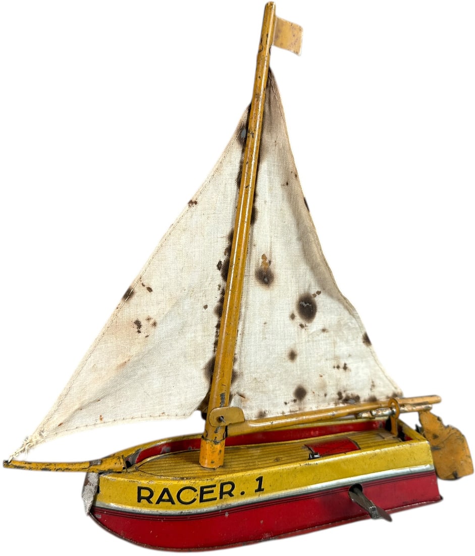 JAPANESE RACER 1 SAILBOAT: 260. JAPANESE RACER 1 SAILBOAT | 8" l. | Staining to original sails, tinplate is in (Excellent Condition) | $300 - $600