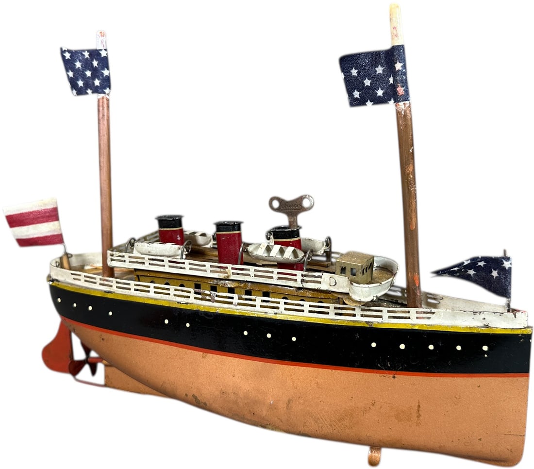 SMALL BING OCEAN LINER: 318. SMALL BING OCEAN LINER | Germany, wind-up motor. | 10.5" l. | Replacement masts and flags, original hull paint displaying in (Very Good to Excellent Condition) | $300 - $600