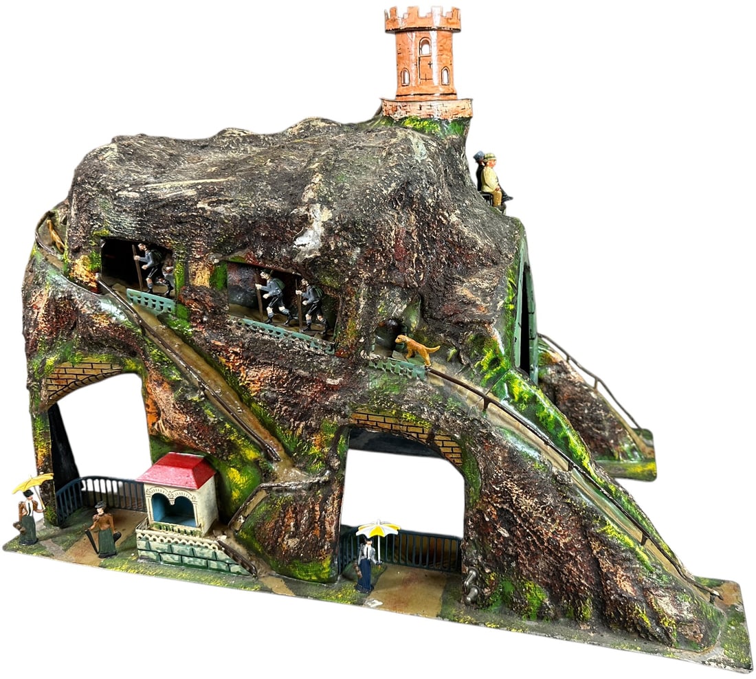 MARKLIN MOUNTAIN TUNNEL: 327. MARKLIN MOUNTAIN TUNNEL | Gauge 1, hand painted, includes attractive contemporary figures. | 18.5 x 11.5 x 16" lwh. | Removable castle at top is a common replacement piece, otherwise all original