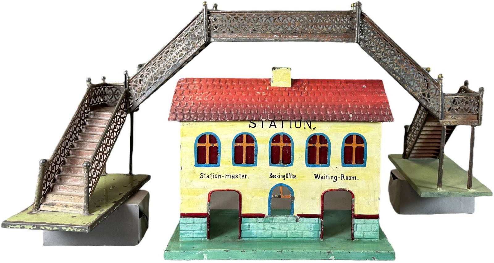 EARLY KIBRI STATION & PEDESTRIAN BRIDGE: 331. EARLY KIBRI STATION & PEDESTRIAN BRIDGE | Gauge 1, hand painted. | 12 x 5.5" lw station | One base and piece of fence on bridge is replaced, bridge overall very good condition, station is (Excell