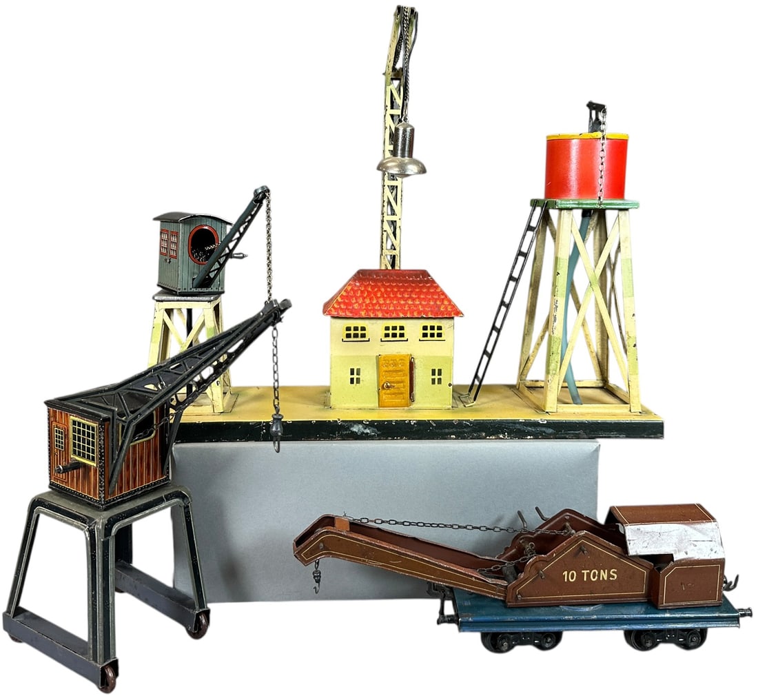 GERMAN TRAIN ACCESSORIES W/ CRANES: 351. GERMAN TRAIN ACCESSORIES W/ CRANES | Four pieces to include a Bing 0 gauge 8 wheel crane car, a Bing gantry crane with rollers, Marklin freight shed with crane and a Kibri industrial platform. |