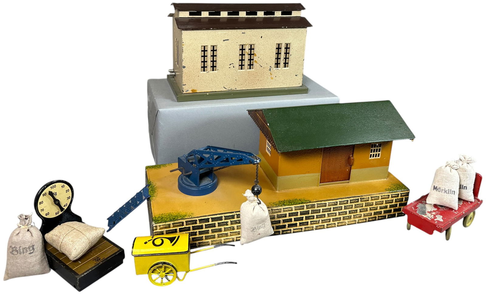 MARKLIN SHED, FREIGHT STATION, & ACCESSORIES: 352. MARKLIN SHED, FREIGHT STATION, & ACCESSORIES | O gauge. | 14" l. | Brown roof on small station repainted, Overall (Excellent Condition) | $250 - $500