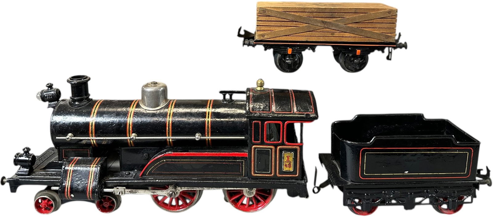 BING ELECTRIC 4-4-0 & BOXED LUMBER WAGON: 364. BING ELECTRIC 4-4-0 & BOXED LUMBER WAGON | Gauge 1, electric. | 11.5" l. loco | Missing one headlight, tender restored and locomotive has extensive repainting throughout, displays in very good to