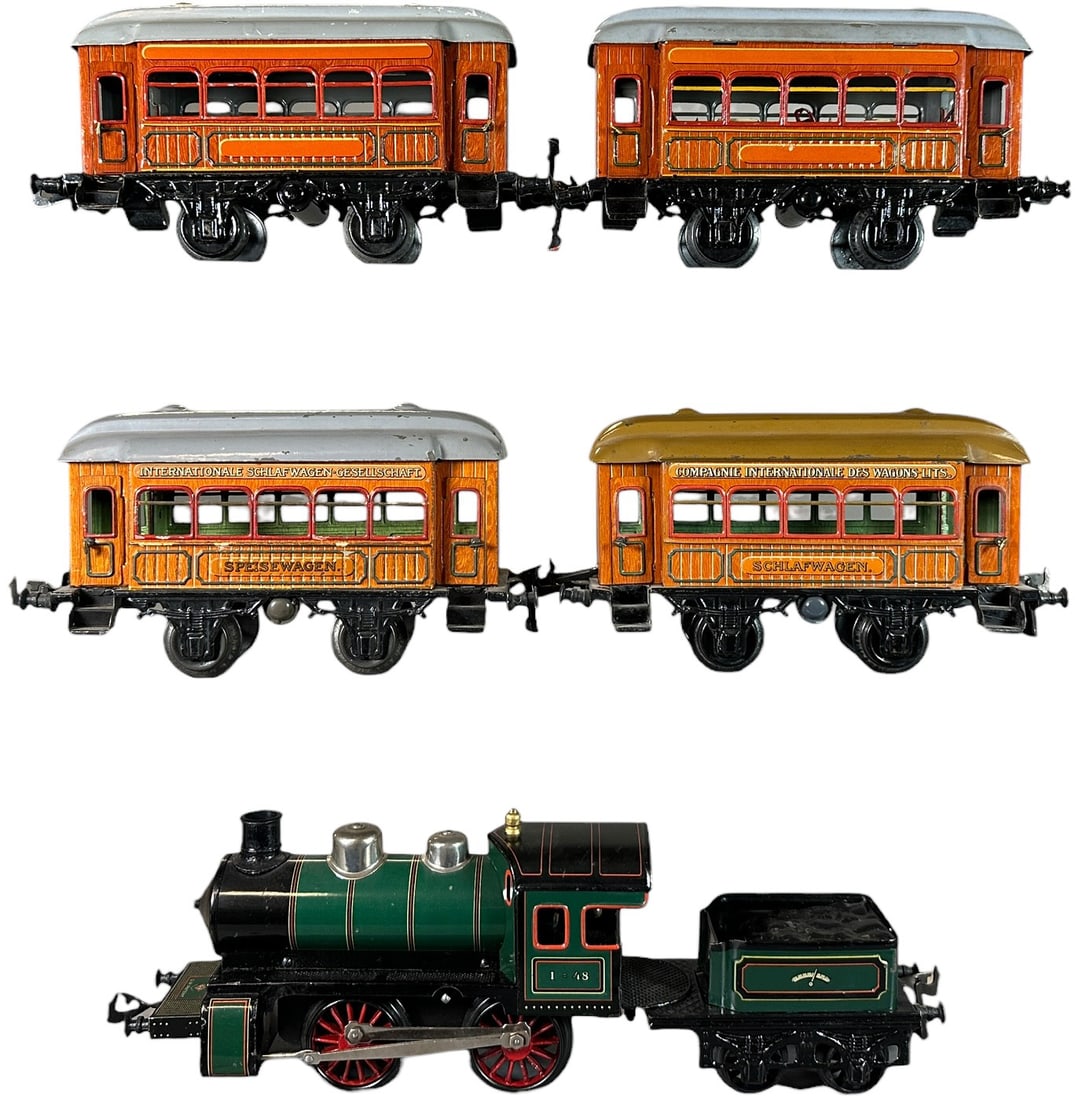 CLOCKWORK BING TEAK PASSENGER TRAIN SET: 368. CLOCKWORK BING TEAK PASSENGER TRAIN SET | Gauge 1, clockwork, litho. | 8.5" l. loco | Minor touch-up to edge of loco cab, overall (Excellent Condition) | $300 - $600