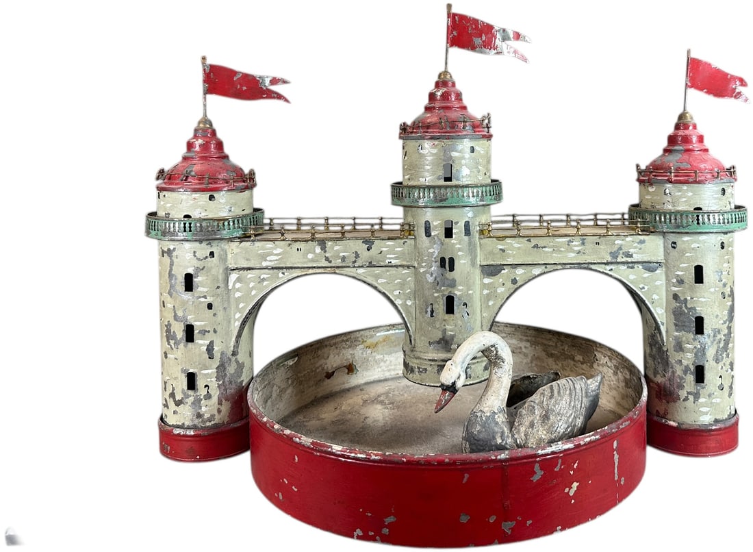LARGE FLEISCHMANN CASTLE W/ POND: 375. LARGE FLEISCHMANN CASTLE W/ POND | Germany, circa 1908, clockwork motor driven. | 15" X 21" | Original castle paint with some overpaint to reds and at swans neck, rotating post for swimming absen