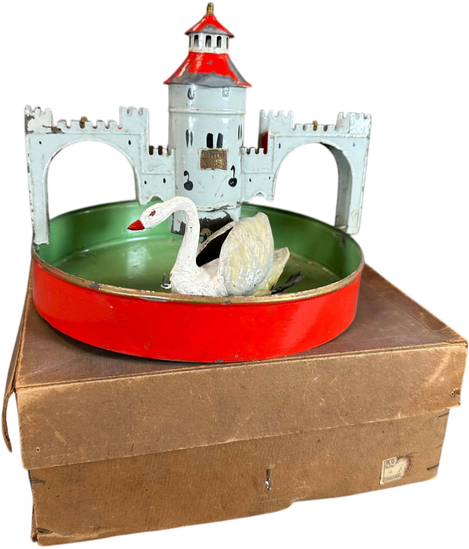 BOXED FLEISCHMANN CASTLE W/ POND: 376. BOXED FLEISCHMANN CASTLE W/ POND | Germany, circa 1908, clockwork motor driven. | 8" l. | Swan repainted, otherwise (Excellent Condition) for age. | $300 - $600