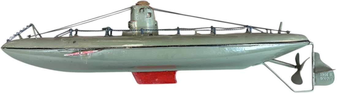 FLEISCHMANN SUBMARINE: 379. FLEISCHMANN SUBMARINE | Beautiful example of one in a series, 1920-1930. | 13.5" l. | Original green paint with wooden flaps and keel added, (Excellent Condition) | $250 - $500
