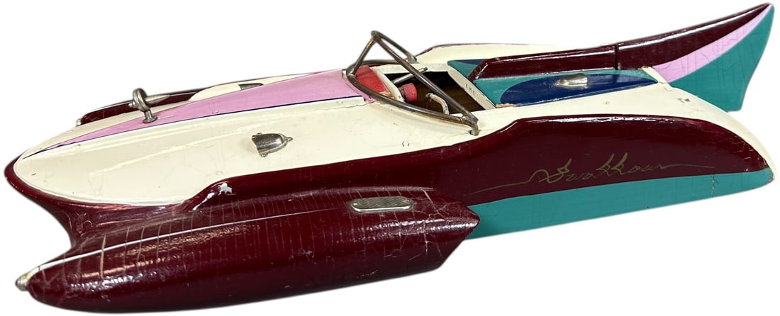 ITO JAPAN SWALLOW TAIL SPEEDBOAT: 385. ITO JAPAN SWALLOW TAIL SPEEDBOAT | Early 1950's wood boat features a battery operated electric motor, removable top compartment gives access to the motor. | 17.5" l. | Missing steering wheel, oth