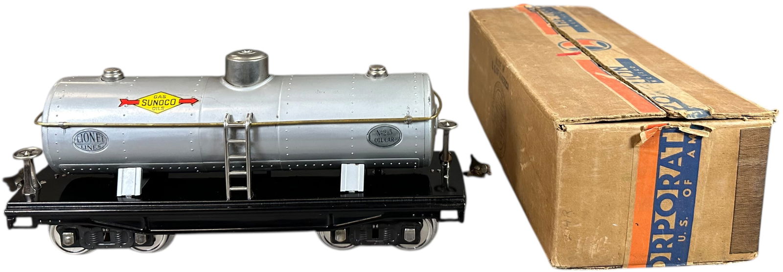PREWAR LIONEL NICKEL TRIM 215 SUNOCO TANK CAR: 434. PREWAR LIONEL NICKEL TRIM 215 SUNOCO TANK CAR | Standard gauge, nickel trim. | 12" l. | One truck missing c-clip that holds truck to frame, touch-up to sides of black frame, otherwise(Excellent t