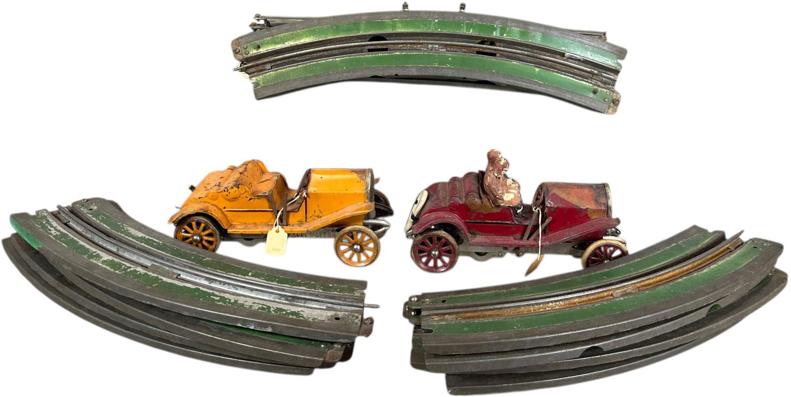 ORIGINAL LIONEL RACE CAR SET: 450. ORIGINAL LIONEL RACE CAR SET | Electric, lot includes eight inside curve pieces and eight outside oval pieces. | 8" l. | One spare tire and one set of figures missing, authentic figures have expe