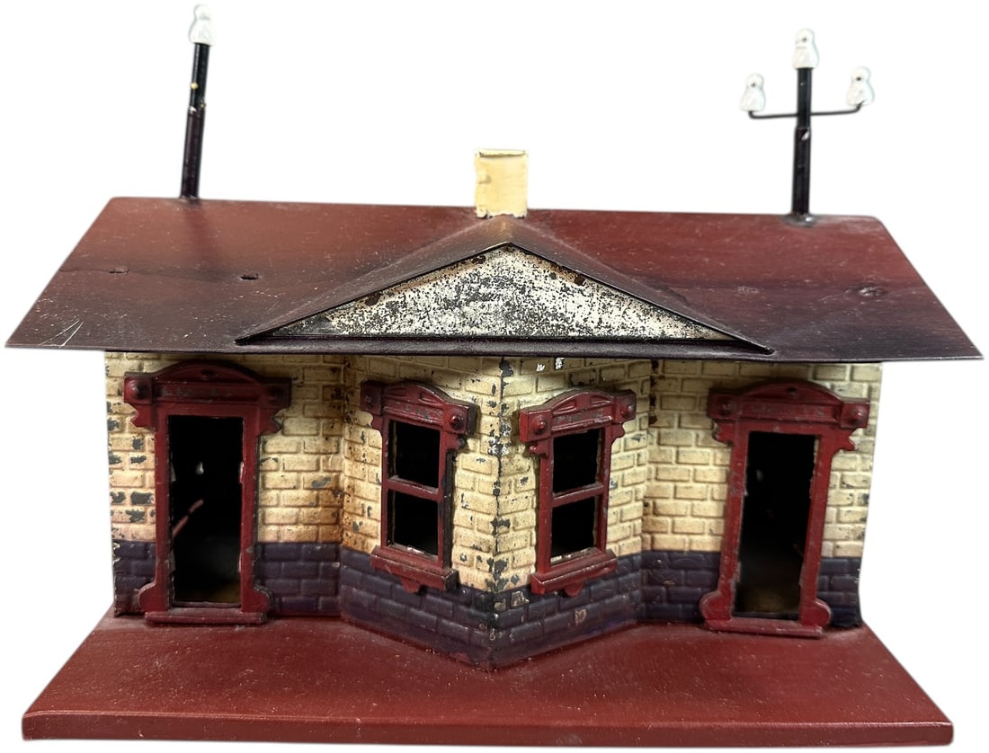 EARLY LIONEL NO.24 PASSENGER STATION: 490. EARLY LIONEL NO.24 PASSENGER STATION | Lionel's first station made for them by a German manufacture, circa 1906, features cast lead window inserts and embossed brick sides. Provenance: Bradley Ka